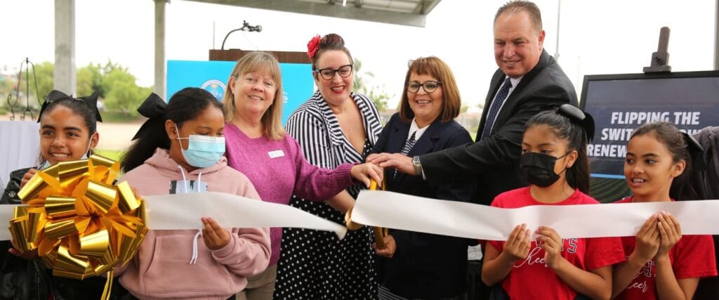 Students and school officials at ribbon-cutting ceremony celebrating a school solar project in California.